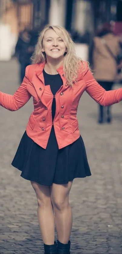 Joyful woman in orange jacket on city street.