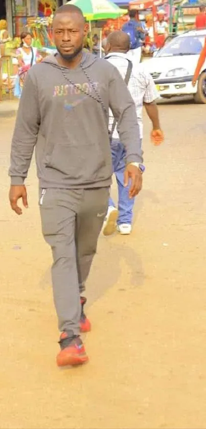 Man walks through bustling city street scene.