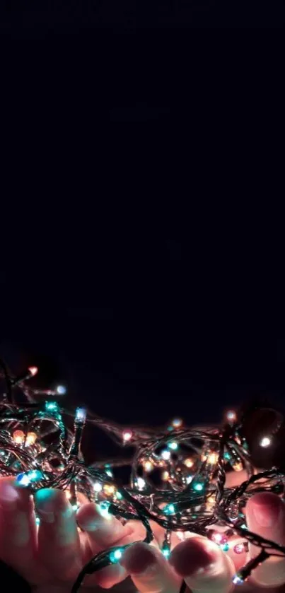 Mobile wallpaper with vibrant string lights in hands against a dark background.