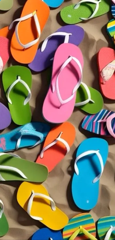 Colorful flip-flops scattered on sand.
