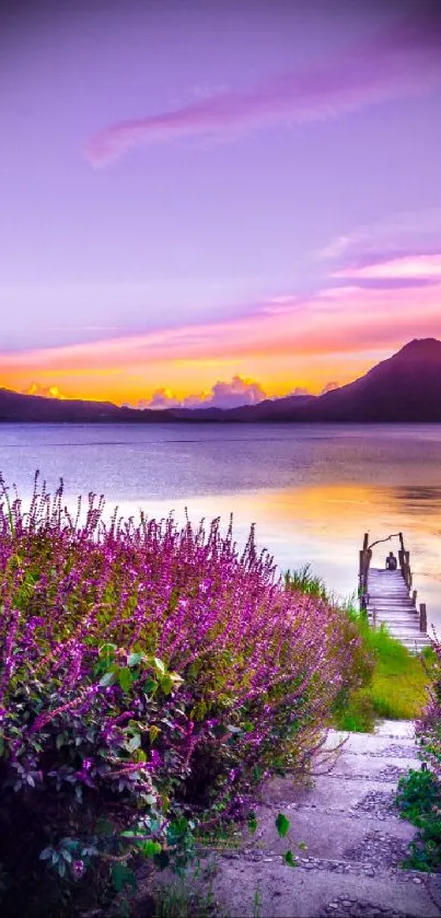 Vibrant purple sunset over a tranquil mountain lake landscape.