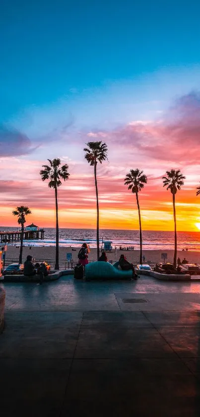 A vibrant sunset over a beach with palm trees and a colorful sky.