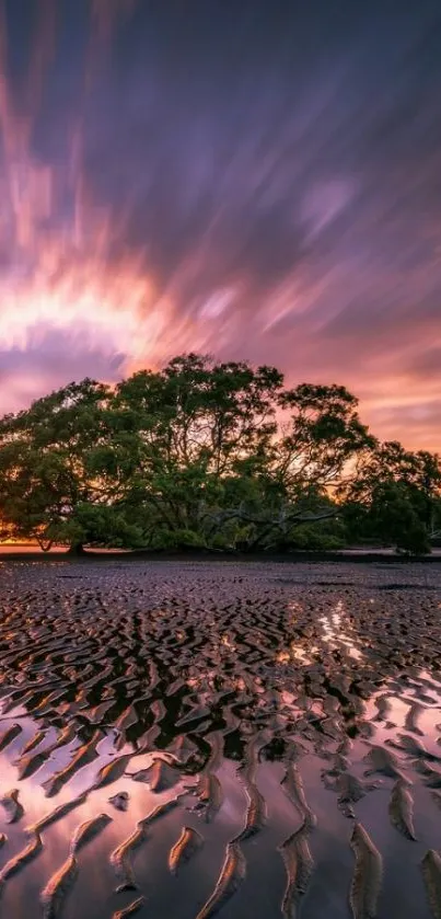 Stunning sunset over rippled sandy beach with vivid sky.