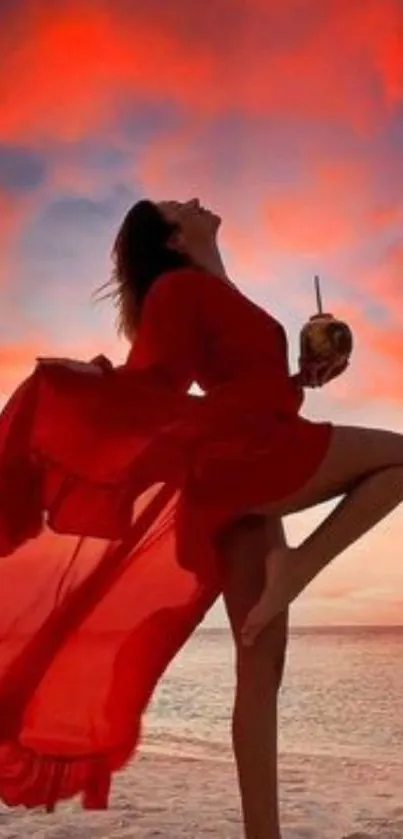 Silhouette of dancer at sunset on beach in red dress, vibrant sky.