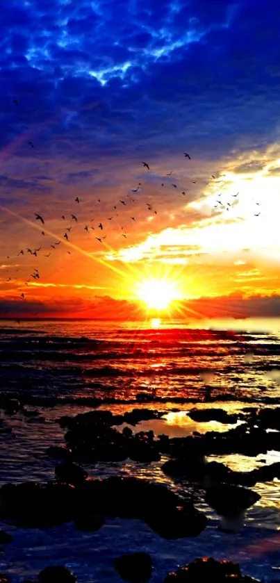 Vibrant sunset over ocean with colorful sky and birds in view.