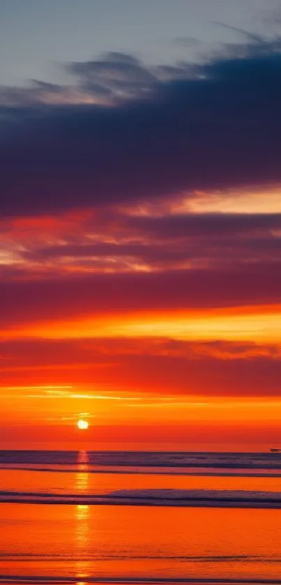 Vibrant sunset over calm beach with colorful sky.