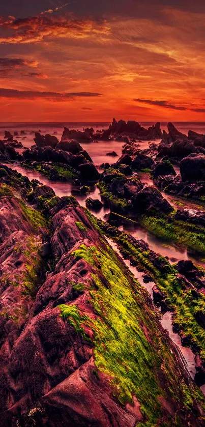 Vivid sunset over rocky beach scene wallpaper.