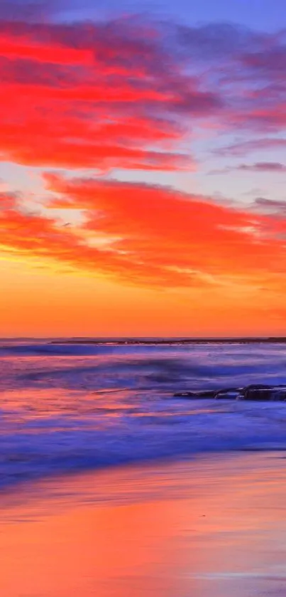 Vibrant sunset at the beach with colorful sky and ocean.