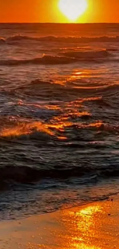 Vibrant sunset over ocean waves on a peaceful beach.