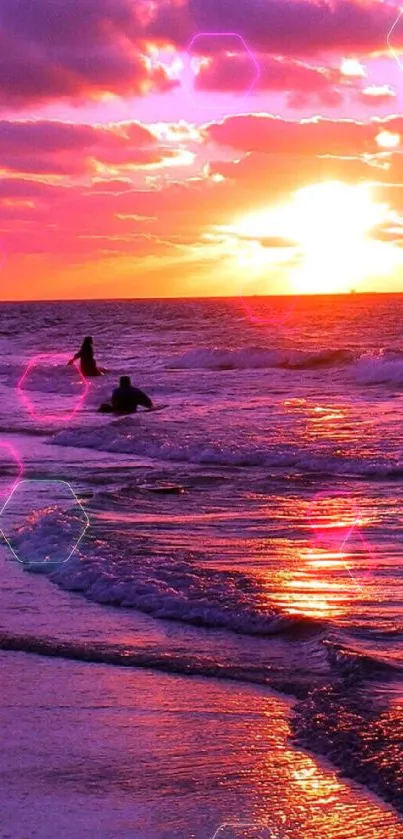 Vibrant pink and orange sunset over ocean waves on a beach.