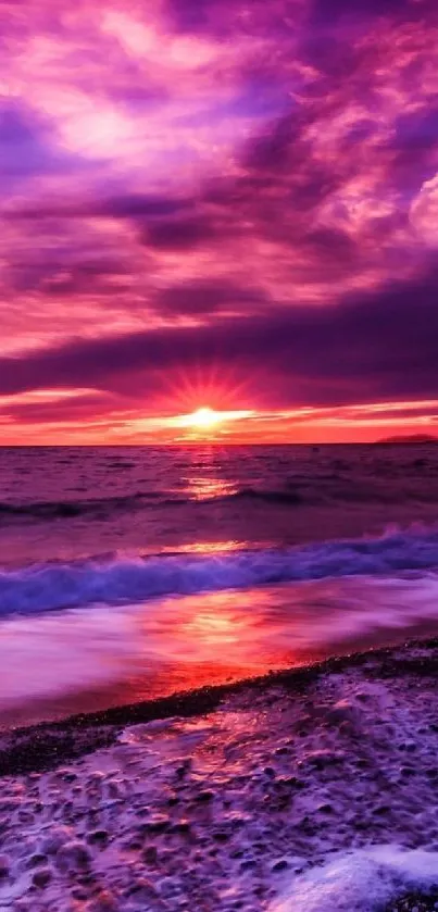 Vibrant sunset beach wallpaper with purple sky and ocean.