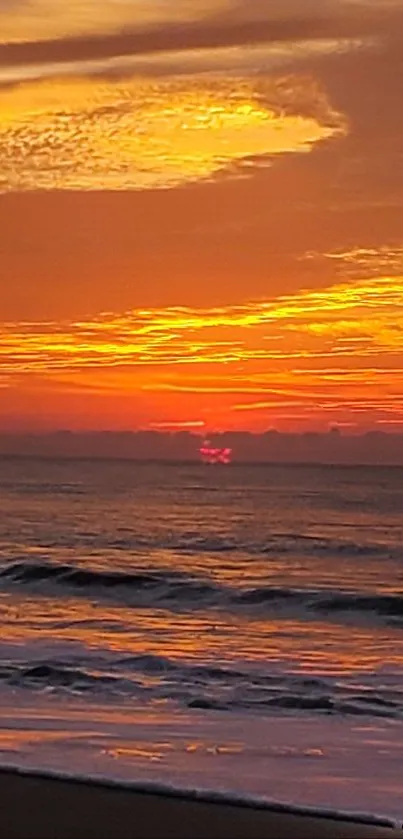 Vibrant orange sunset over a serene beach