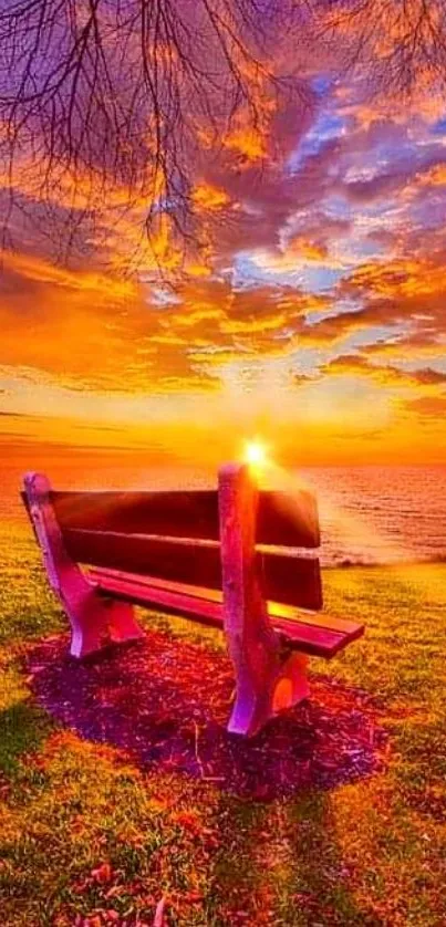 A stunning orange sunset over a bench by the water.