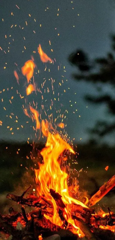 Mobile wallpaper of a vibrant campfire burning at night.