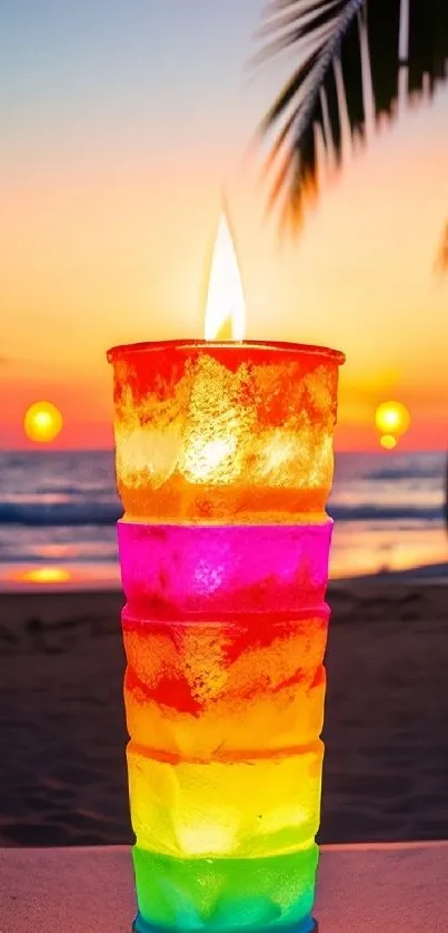 Colorful candle with vibrant sunset on beach.