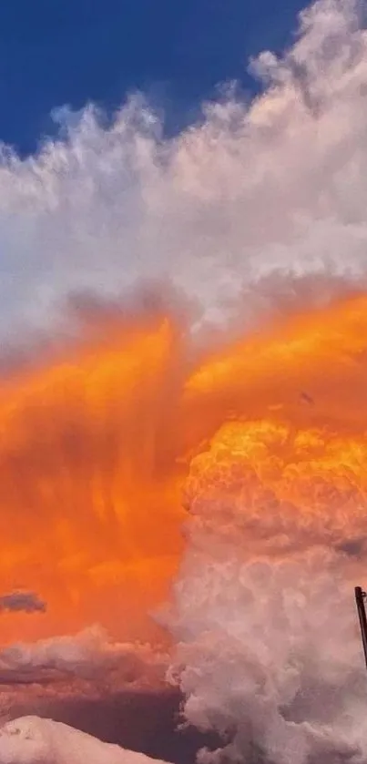 Vibrant orange sunset clouds with blue sky background.