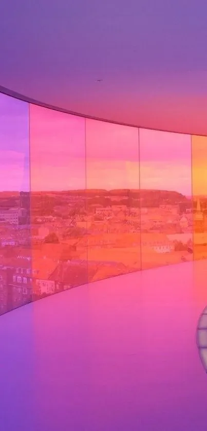 Vibrant pink and orange sunset seen through a glass corridor overlooking a cityscape.