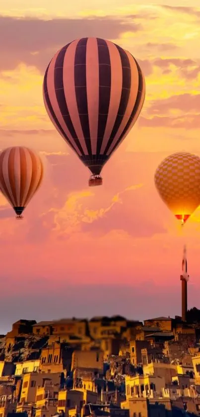 Hot air balloons floating over a cityscape at sunset with vibrant orange hues.