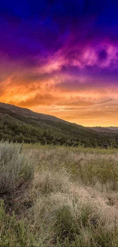 Vibrant sunset over a mountain landscape with colorful sky.