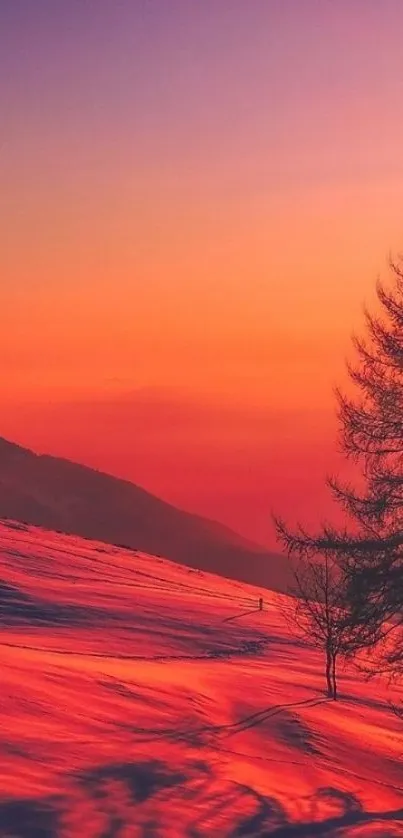 Vibrant sunset over snow-covered mountains with a striking orange and purple sky.