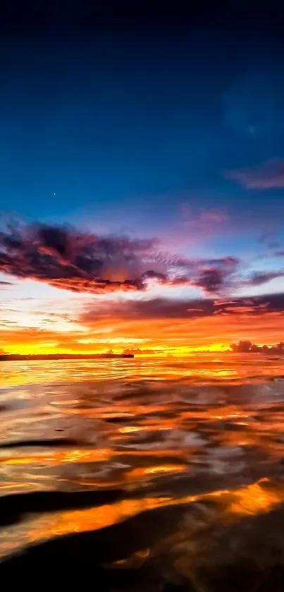 Captivating sunset over a vibrant ocean view, with orange and blue hues.