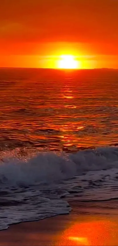 Vibrant orange sunset over ocean waves with a serene atmosphere.