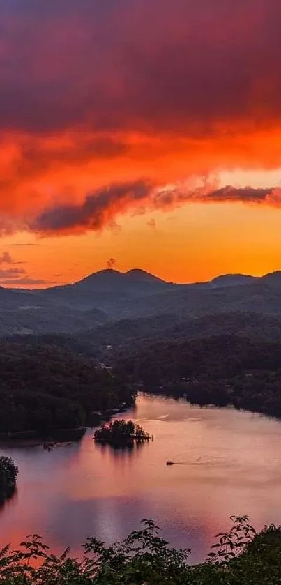 A vibrant sunset over mountains and a lake, with glowing orange skies.