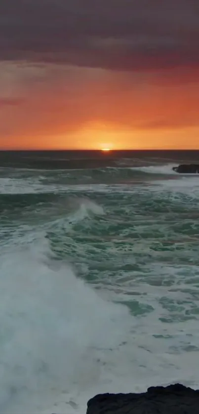 Vibrant sunset over ocean waves with orange sky.