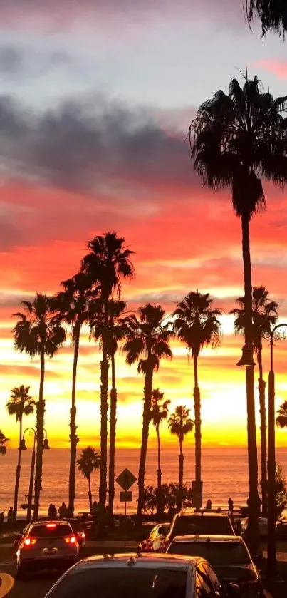 Mobile wallpaper of a vibrant sunset with palm trees by the beach.