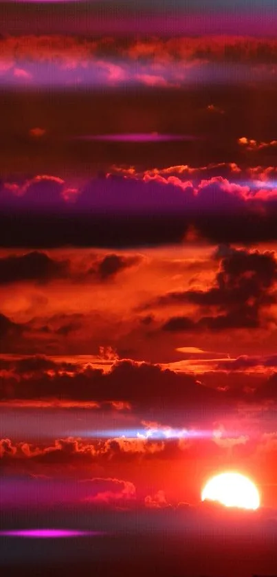 Vibrant sunset with red sky and clouds.