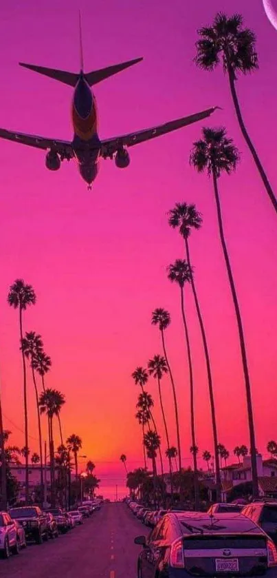 Plane flying at sunset over palm trees with a vivid pink sky.