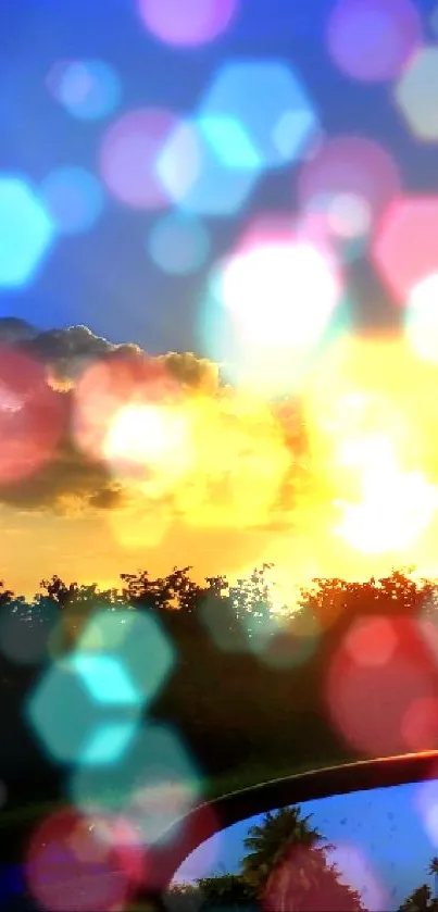 Vibrant sunset seen through a car window with blue skies and clouds.