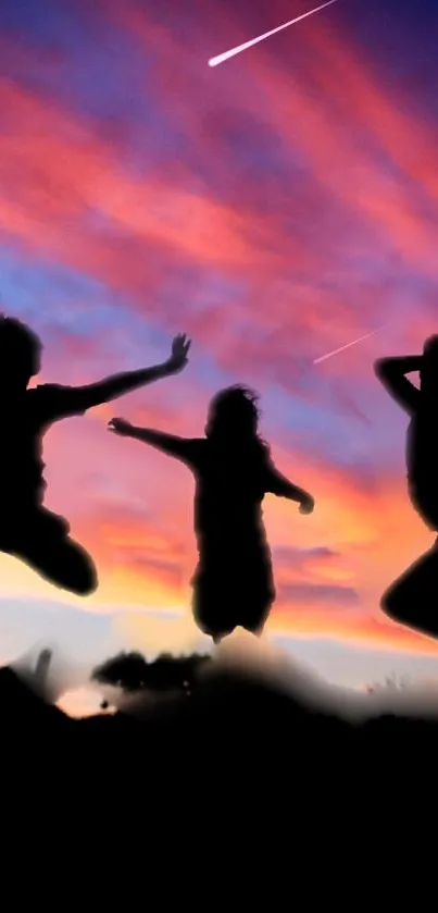Silhouetted figures jump against a vibrant sunset sky with colorful clouds.