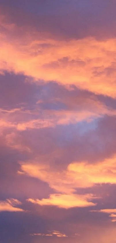 Vibrant pink and purple sunset sky background with clouds.