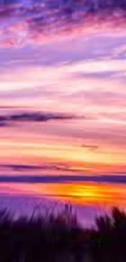 Colorful sunset sky with purple, pink, and orange hues over the horizon.