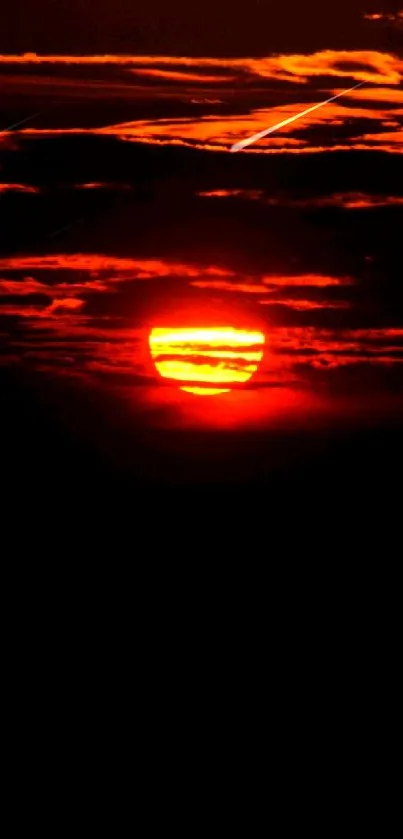 Vibrant sunset with dark red sky and dramatic clouds.