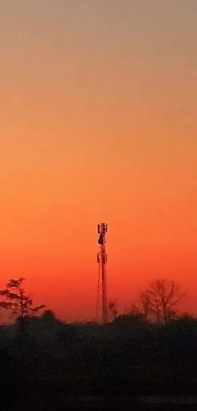 Silhouette of a tower against a vibrant sunset gradient sky.