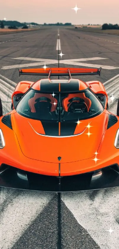 Vibrant orange supercar on an open runway with dramatic winged doors.