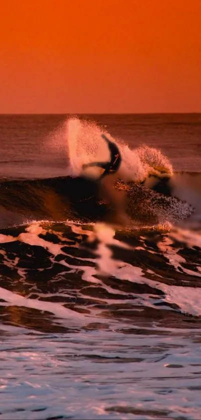 Surfer rides orange waves at sunset.