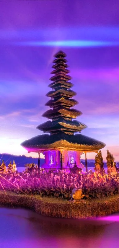 Balinese temple silhouetted against a vibrant purple and pink sunset.