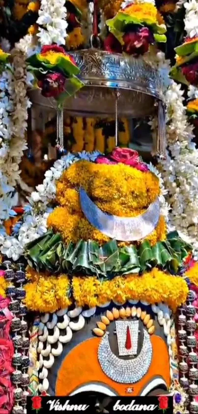 Temple deity adorned with colorful flowers and traditional decor.
