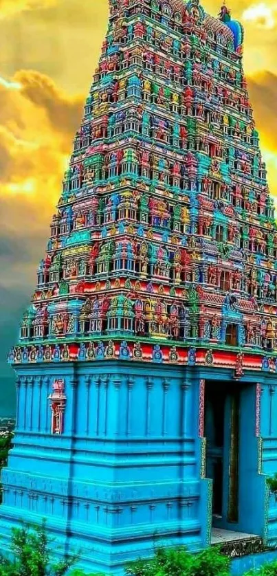 Intricate temple tower with vibrant colors under dramatic sky.