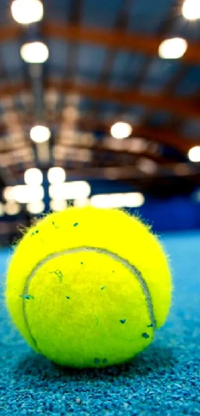 Close-up of a vibrant tennis ball on a blue court.