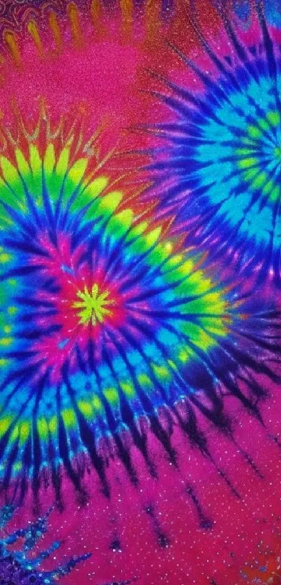 Vibrant tie-dye pattern wallpaper with pink, blue, and yellow colors.