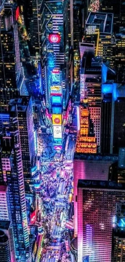 Aerial view of Times Square illuminated at night with vibrant neon lights.