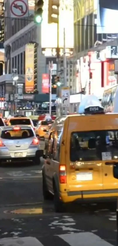 Busy Times Square street with yellow taxis and city lights.