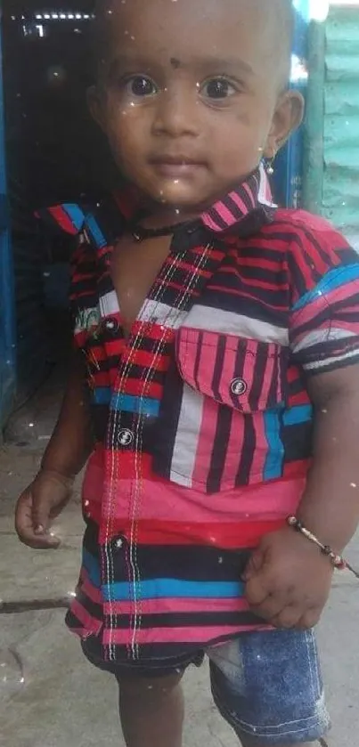 Vibrant toddler in colorful striped shirt.