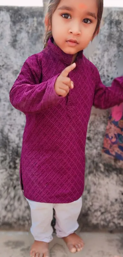 Cute child in purple outfit with natural background.