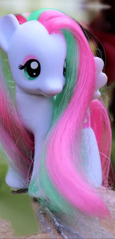 Vibrant toy pony with pink and green hair on mobile wallpaper.