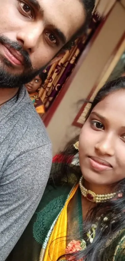 Couple in vibrant traditional attire posing.